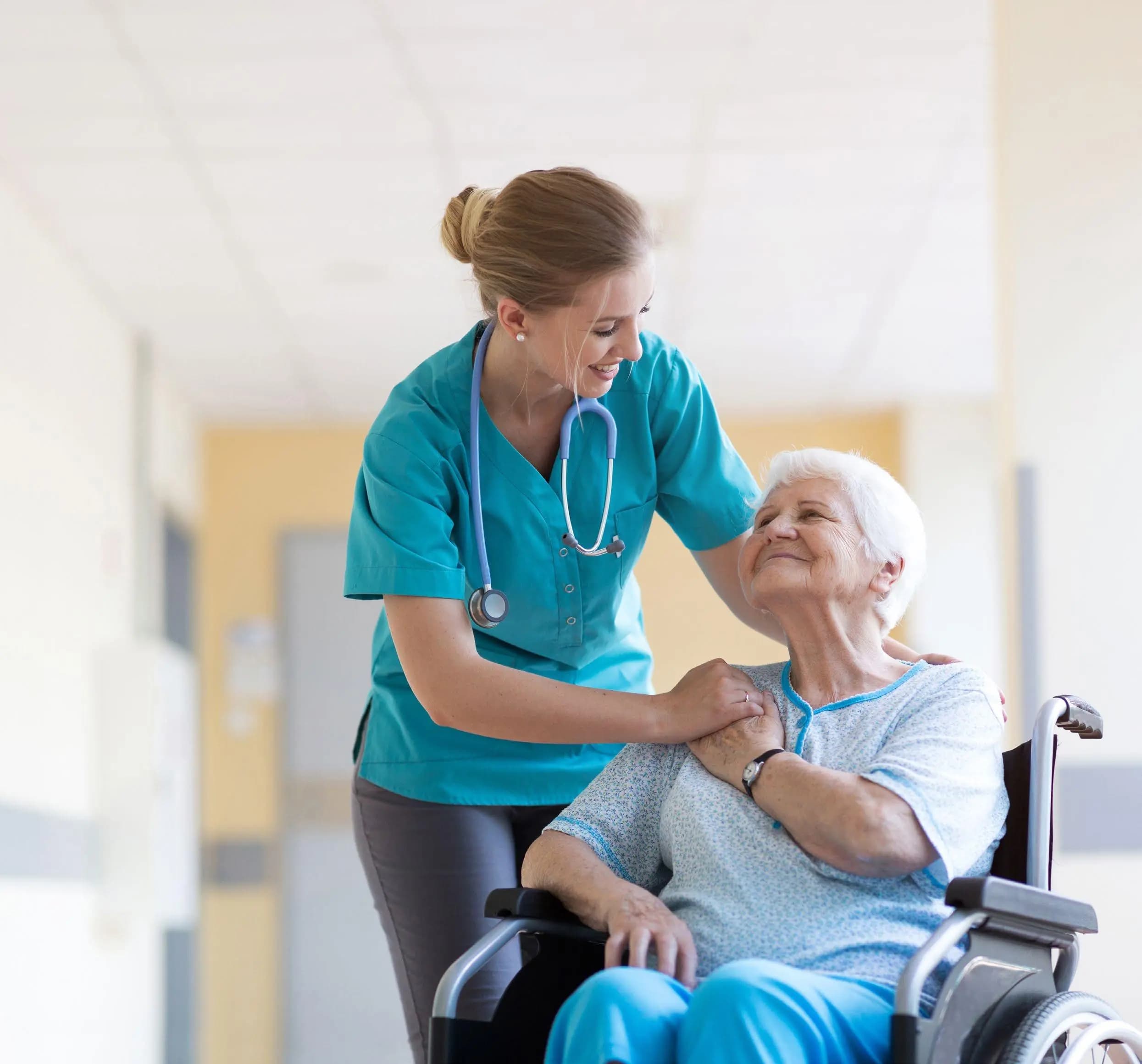 Nurse supporting an elderly woman in a bright care setting