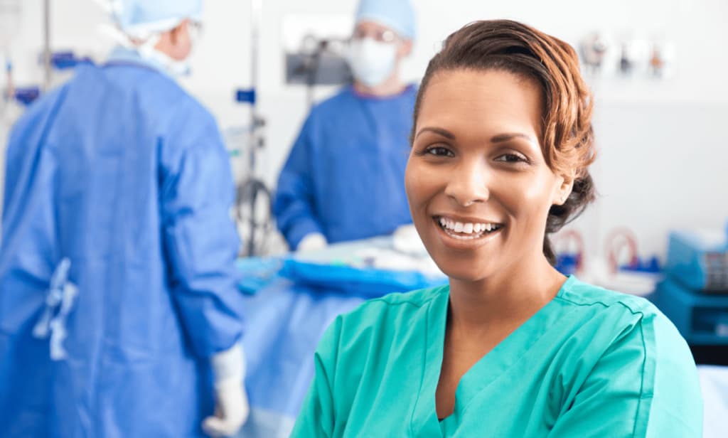 Smiling healthcare worker in green scrubs