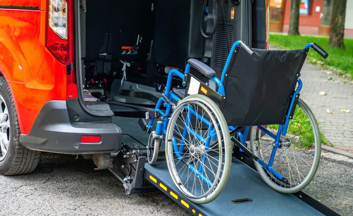 Wheelchair beside an accessible transport vehicle